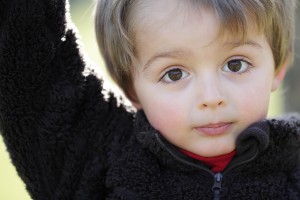 Three year old portrait of innocence outdoor in the sunlight